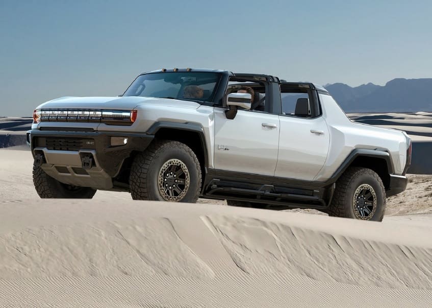 2022 GMC Hummer EV Pickup Truck side front view on sand